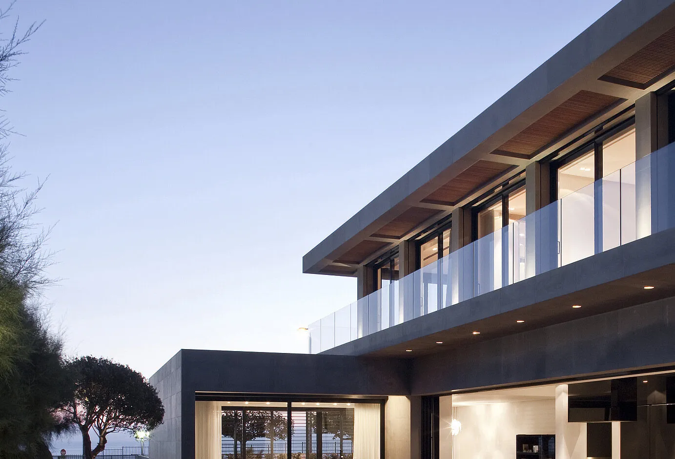 Modern villa at dusk, glazed with slim aluminium windows and doors