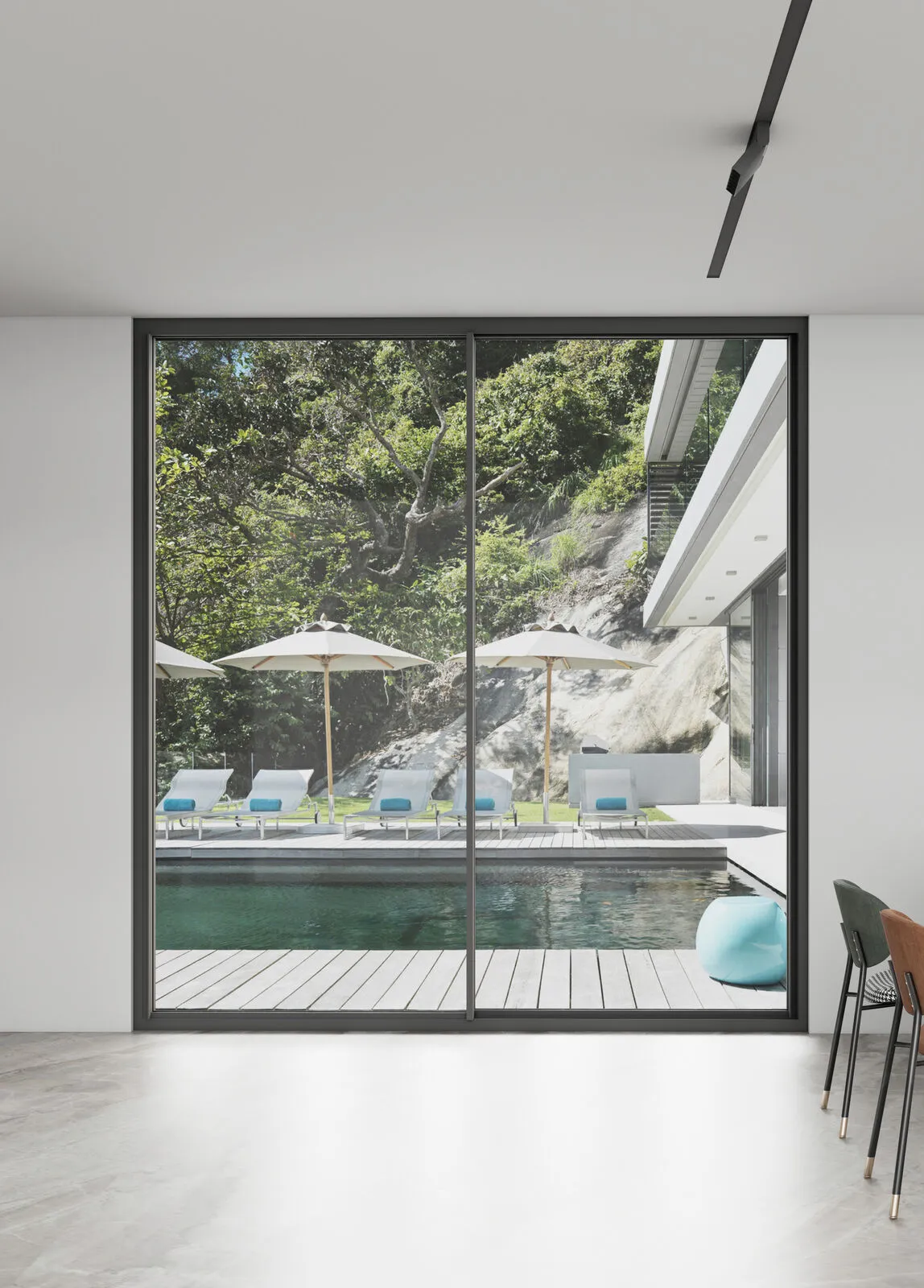 Slim sliding door opening onto a poolside terrace
