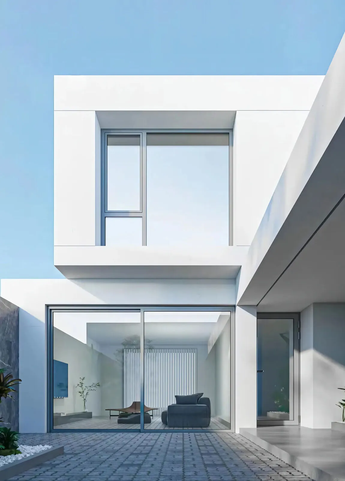 Black leather chairs facing sliding glazing to a sunny courtyard